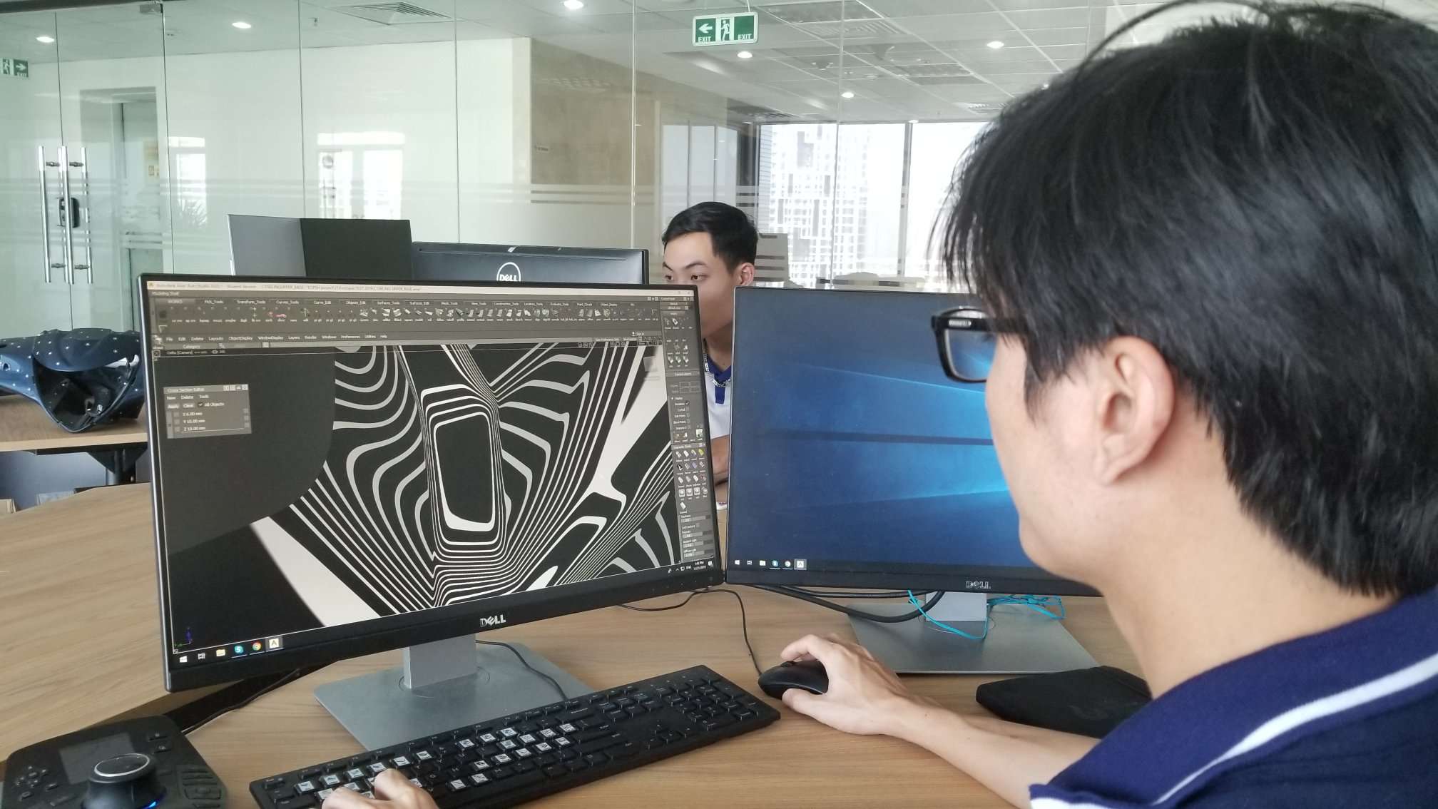 A PSH Design modeller working on Class A surfaces in Autodesk Alias, zebra analysis on screen, in the Hanoi studio